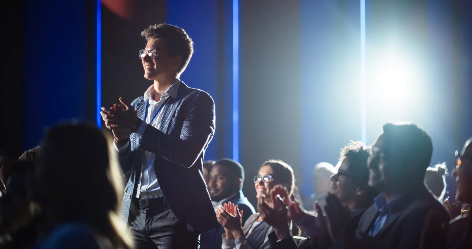 Audience member standing and clapping