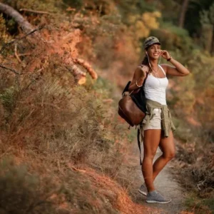 Woman walking on a forest trail during autumn.
