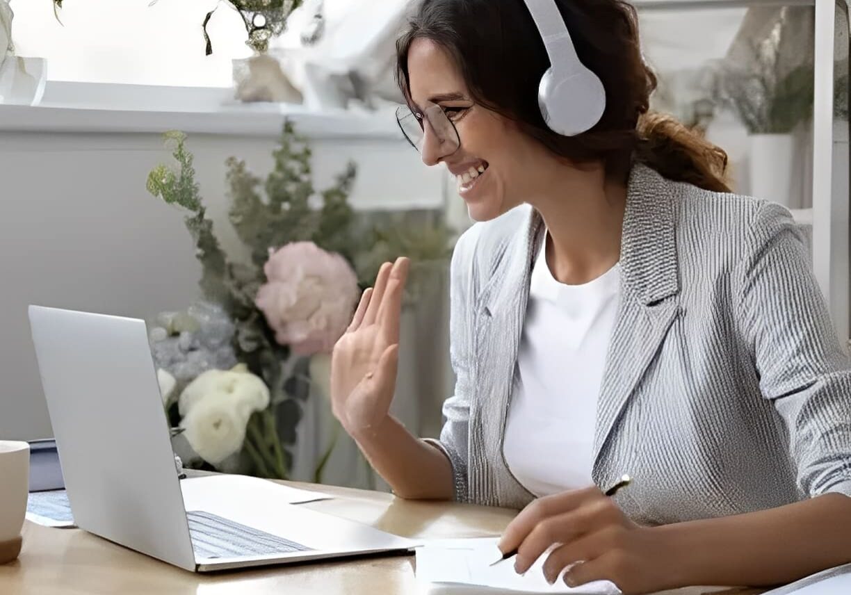 Person working remotely with laptop and headset
